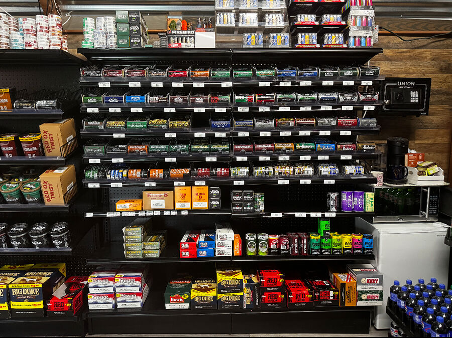 Shelves of smokeless tobacco cans and tubs
