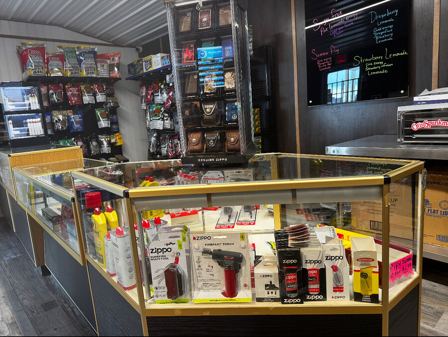 Glass display cases of Zippo lighters, torches and smoking accessories
