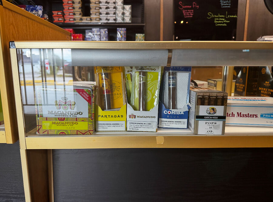 Tubed Macanudo, Partagas and Cohiba cigars in the counter case